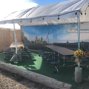 tables and chairs under a tent