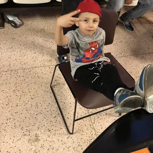 a young boy sitting in a chair