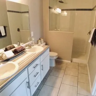 Double vanity, glass shower and heated bathroom floor