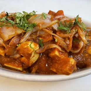 Karahi Paneer. Cheese cubes roasted with bell peppers, tomatoes, and sautéd onions.
