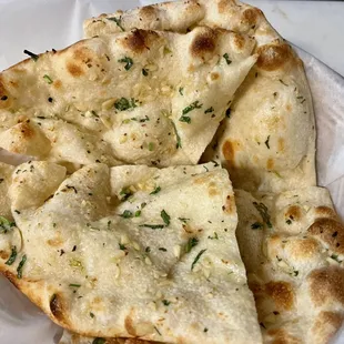 Garlic Naan. Garlic smothered flatbread baked in tandoori.