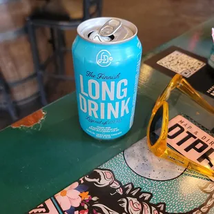 a can of long drink and sunglasses