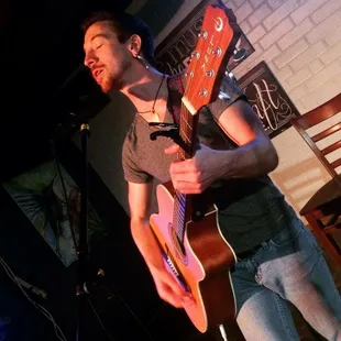 a man playing a guitar on stage