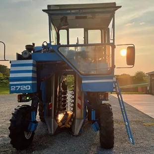 a blue tractor parked in a parking lot