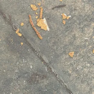 Nails and wood chips left from maintenance breaking apart old furniture where you drive