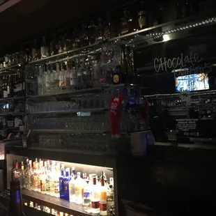 a bar filled with bottles of alcohol