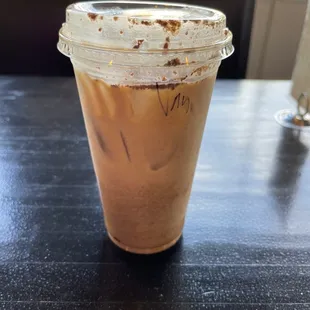 Iced latte with oat milk and cinnamon powder