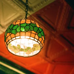 a stained glass lamp hanging from the ceiling