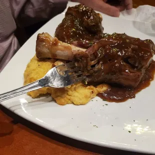 Braised lamb shanks. So tender and delicious.  With cheesy grits.