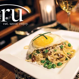 a plate of pasta with a fried egg