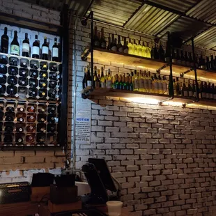a brick wall with bottles of wine on it