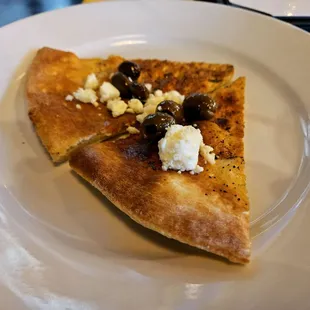 Complimentary crusty pizza crusts with olives and feta