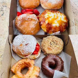 clockwise from upper left: cherry, guava, creme brulee, crumbly crumb, devil's food cake, old fashioned glazed, strawberry shortcake x2