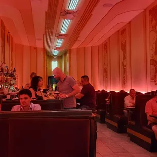 people sitting at tables in a restaurant