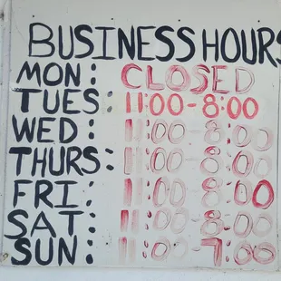 The business hours look like they were written with a finger dipped in blood