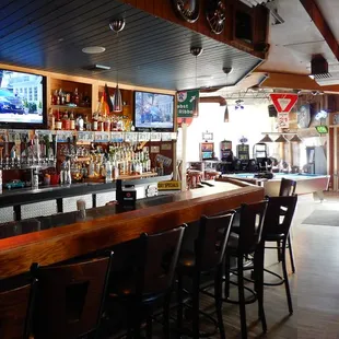 The bar to the right of the entrance, with video gambling and pool table.