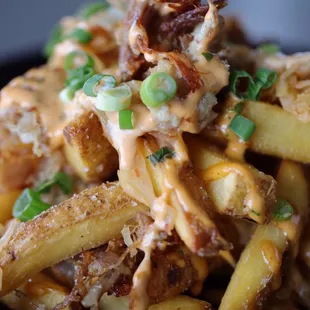 New Smothered Frites Street Fries with Confit Pork Belly, house made quick kimchi, sriracha aioli &amp; green onion