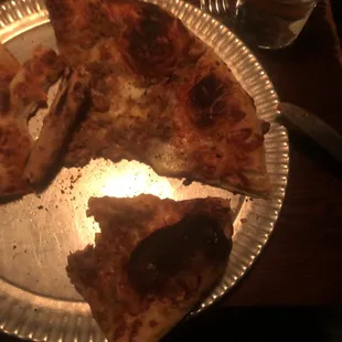 Picture of burnt pizza from a &quot;pizzeria&quot;.