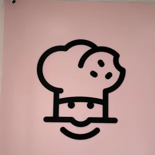 a picture of a chef's hat on a pink wall
