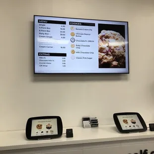 Self order kiosks. You do not have to use these, you can also order w/ cashier. $4.50 a cookie. You decide if it's worth it.