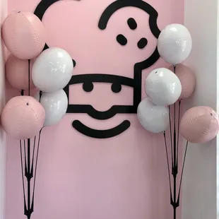 a pink and white balloon display