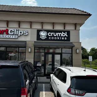 cars parked in front of a crumbl&apos;s