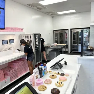 a woman working in a doughnut shop