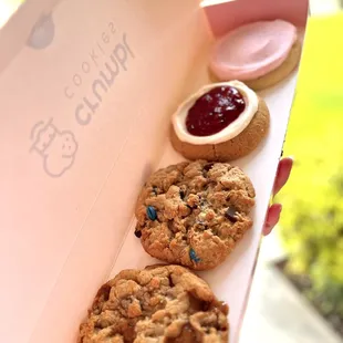 a person holding a box of cookies