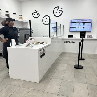 a woman standing in front of a counter