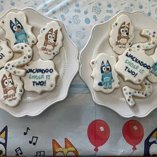 two plates with decorated cookies on them