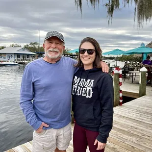 a man and a woman standing on a dock