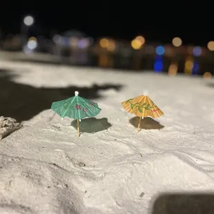 two umbrellas in the sand
