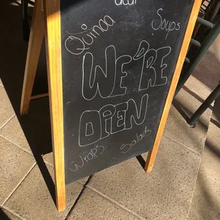 a blackboard with a sign that says open