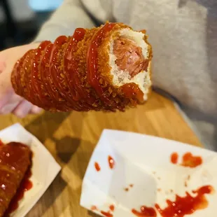 a person holding a hot dog