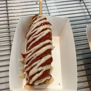 Squid ink dog with ketchup and garlic Parmesan sauce