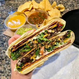 a hand holding a tortilla