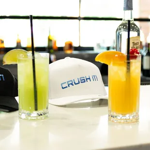 a bar with drinks and hats