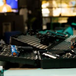 a bunch of guns on a table