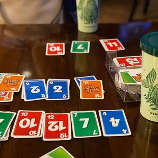 a table with cards and a drink