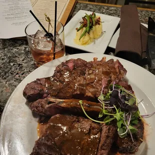 a plate of steak with a side salad