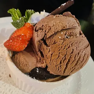 a bowl of ice cream with a strawberry on top