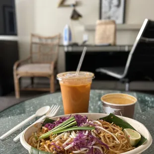 a bowl of noodles and a drink