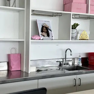 a kitchen with a sink and a laptop