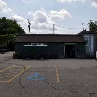 an empty parking lot with a restaurant and a bicycle