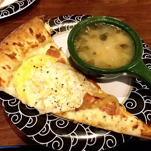 a slice of pizza and a bowl of soup