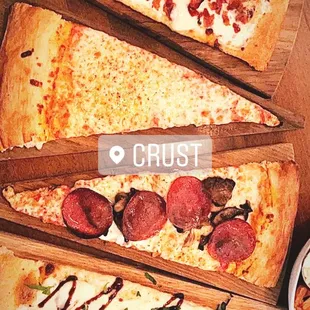 three slices of pizza on a wooden table