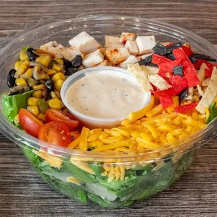 Chipotle Chicken, Romaine, Cherry Tomato, Roasted Corn & Black Beans, Red Onion, Cheddar, Tortilla Chips, Spicy Chipotle Dressing