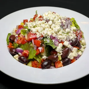 a white plate with a salad on it