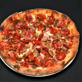 a pizza with pepperoni, sausage, and mushrooms