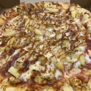 Stuffed crust pizza with chicken breast, pineapple, and barbecue drizzle on top to finish it off.